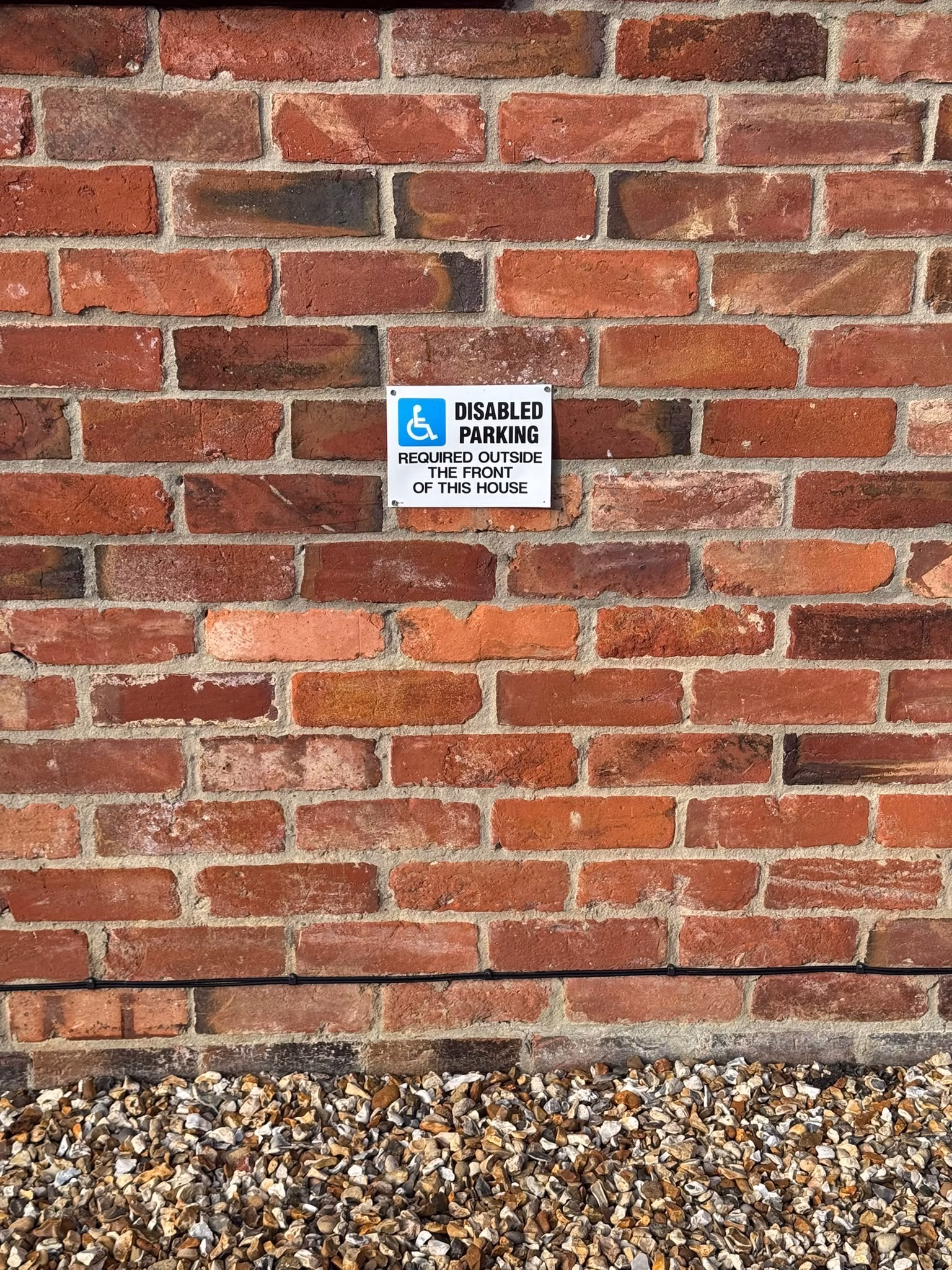 The disabled parking sign on the wall outside The Stables